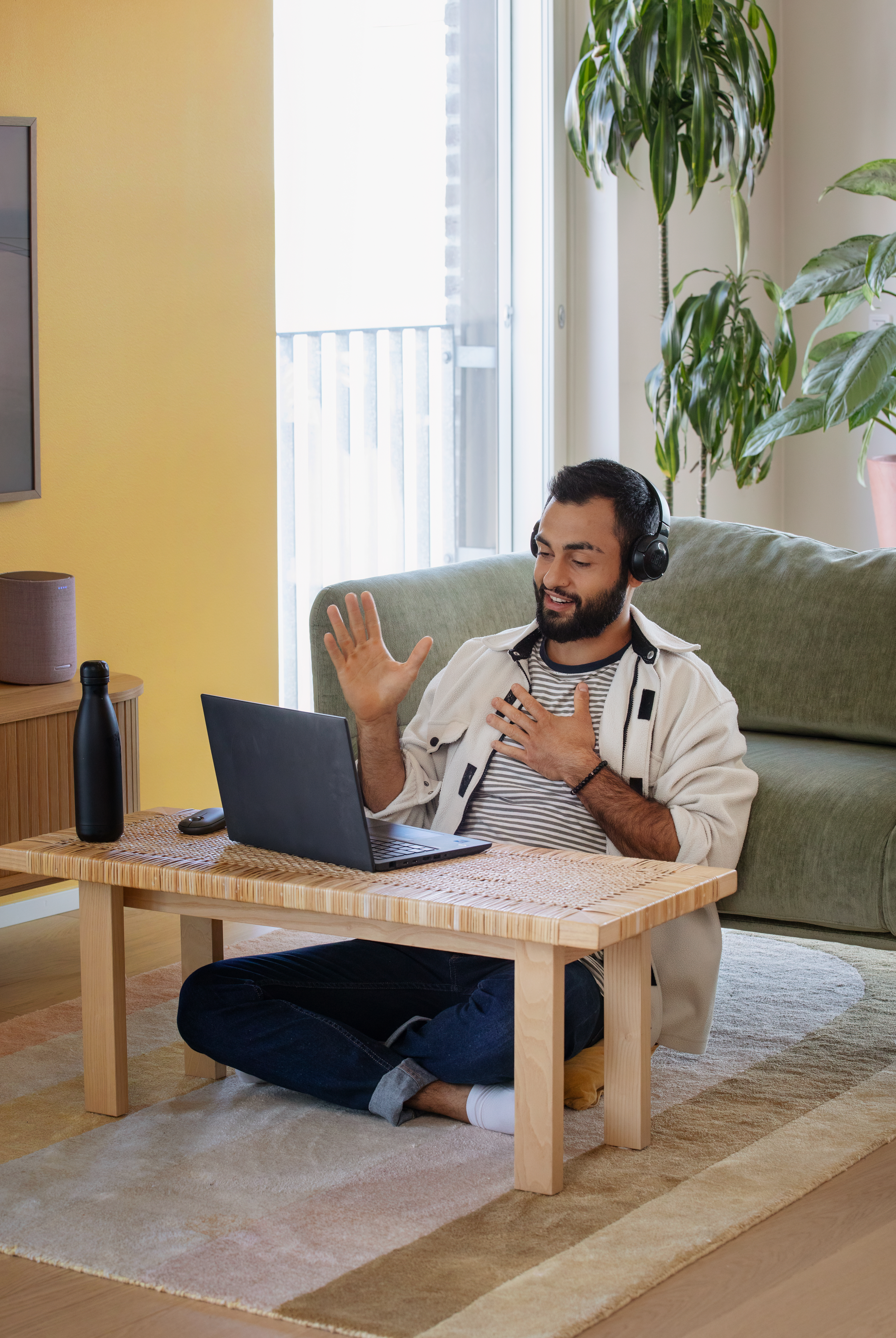 A man participates in a remote meeting.