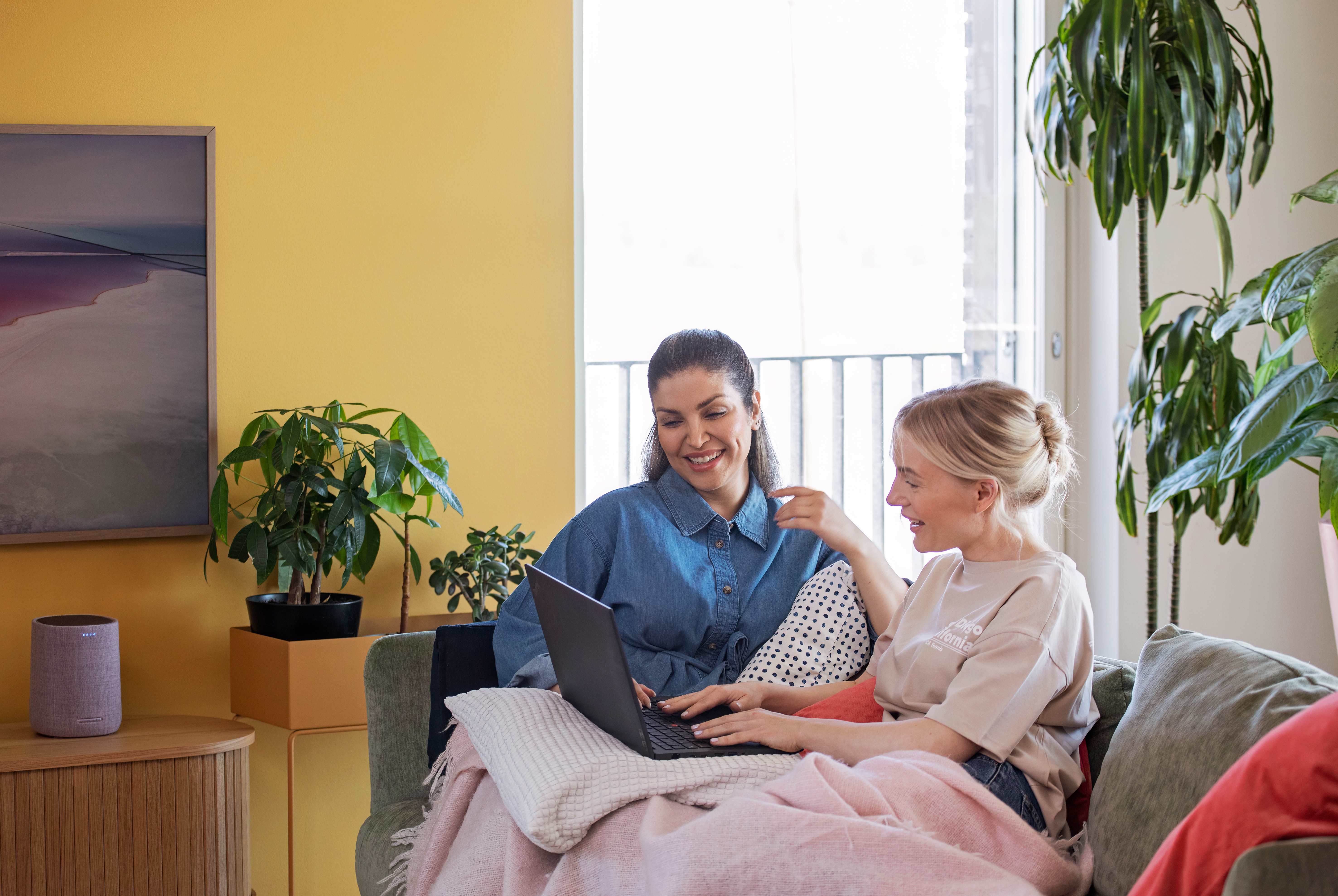 Two woman use computer