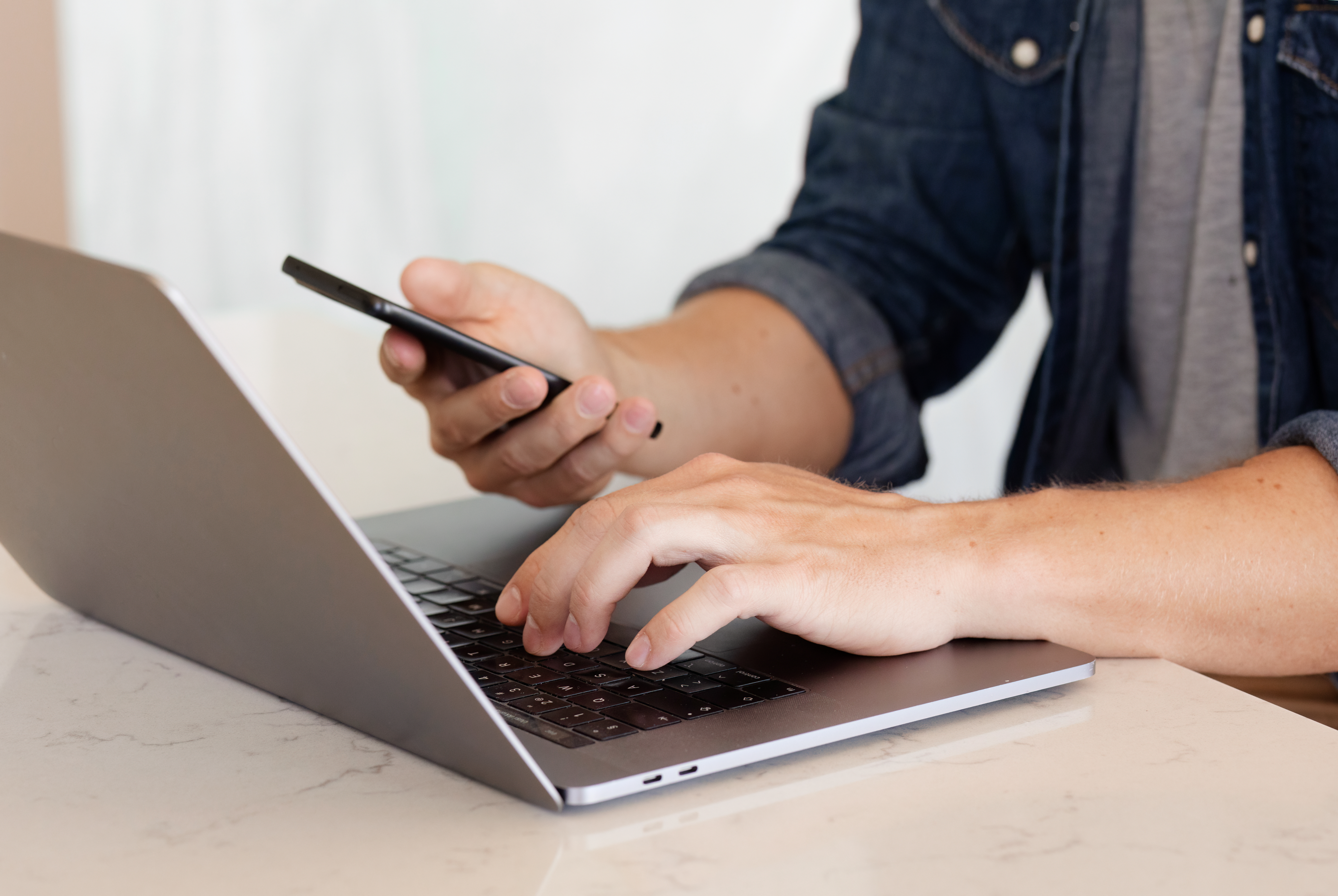 Man is writing on computer.