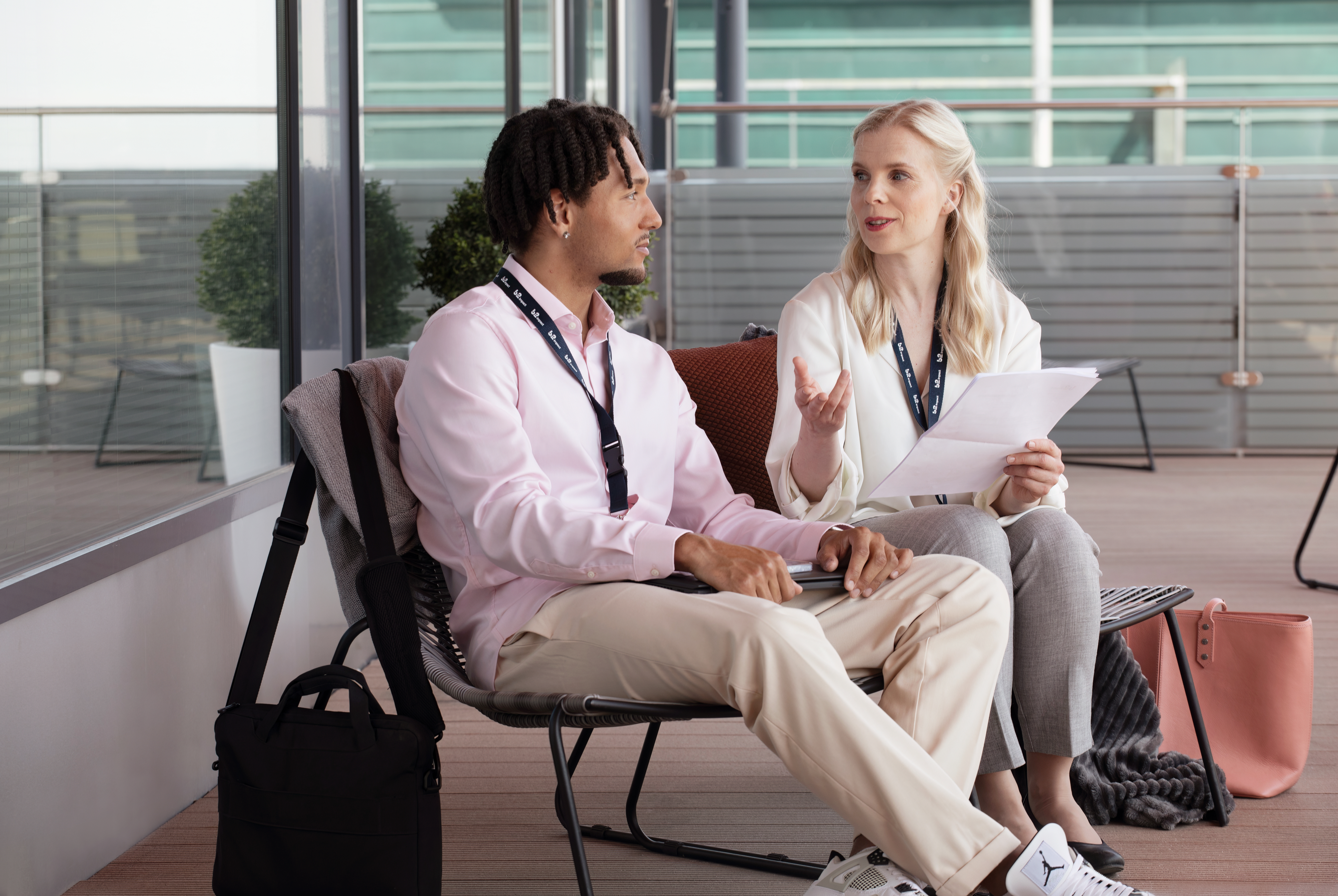 A man and a woman are talking on the roof terrace.