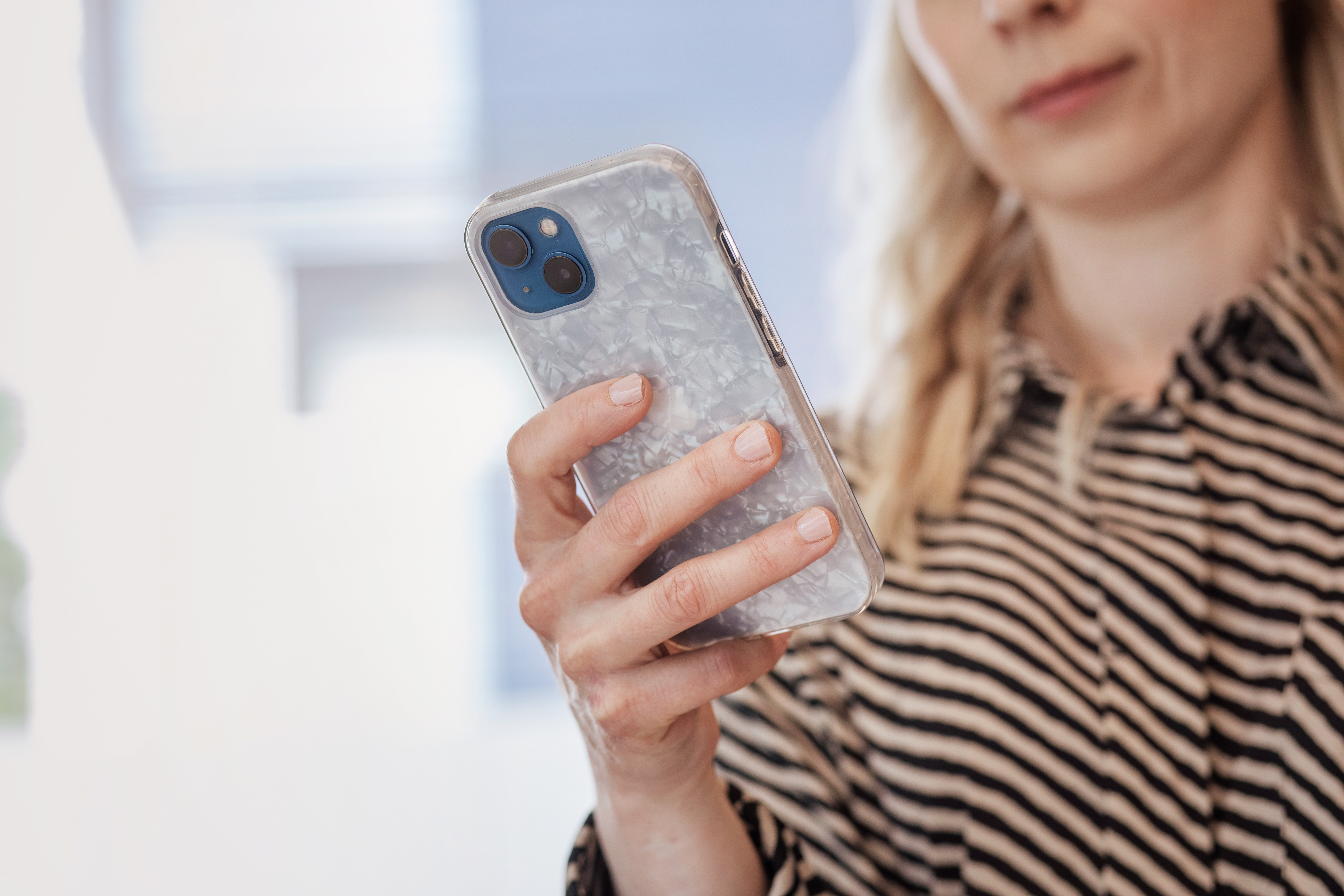 The woman is looking at her phone.