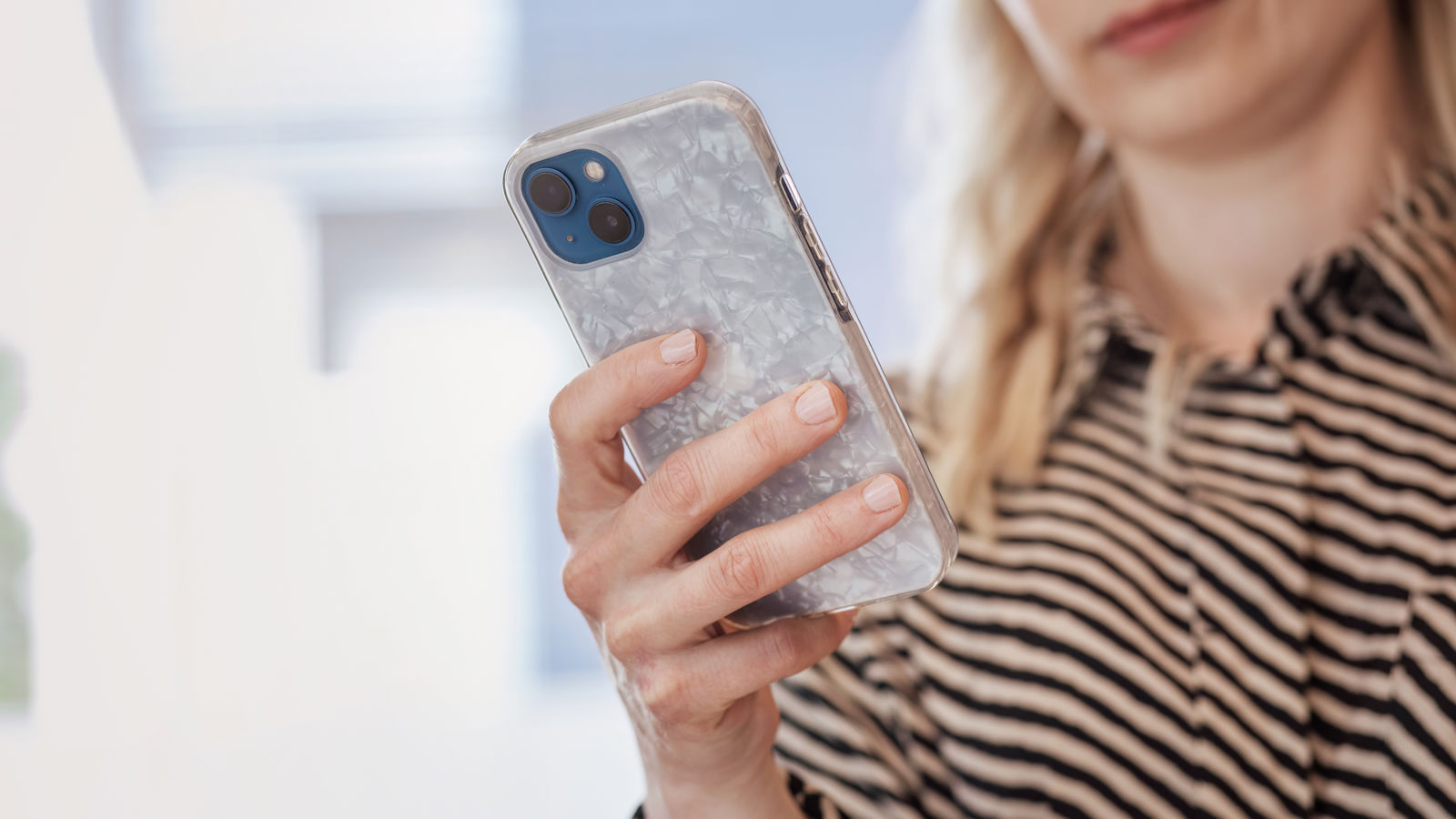 The woman is looking at her phone.